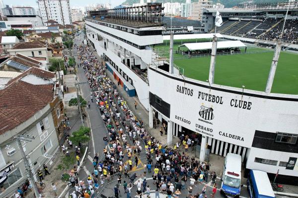 Mourners queue outside Vila Belmiro stadium waiting to pay their respects to Brazilian football legend Pelé during his funeral on Jan. 2, 2023, in Santos, Brazil. 