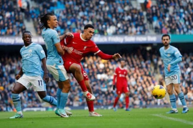 Trent Alexander-Arnold holds off Nathan Aké during the match.