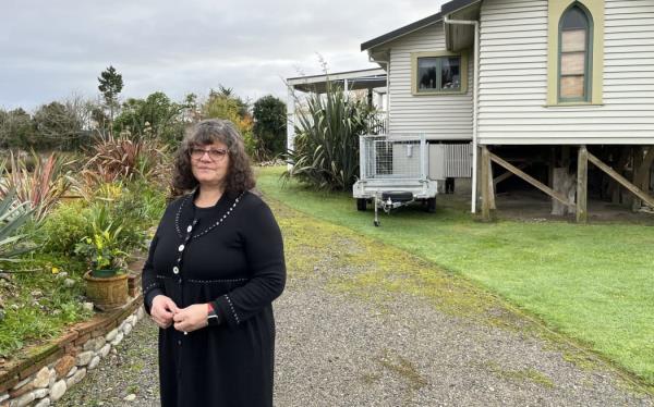 Ruth Vaega outside her Snodgrass Road home in June 2022. The house was raised o<em></em>nto higher foundations following Cyclone Fehi in February 2018 but now may be abando<em></em>ned -- its owners are no clearer two years on from the July 2021 flood.