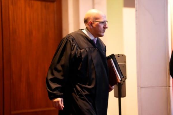 Colorado Supreme Court Justice Carlos Samour Jr enters the chamber for oral arguments on whether to allow former President Do<em></em>nald Trump to be included on the state's general election ballot
