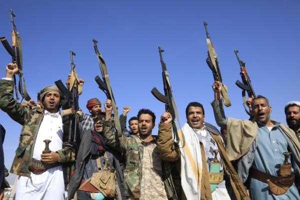 Houthi members and supporters waved their guns around in Sanaa during Monday's parade.