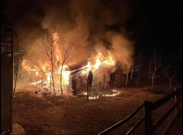 An old building is pictured on fire at night.